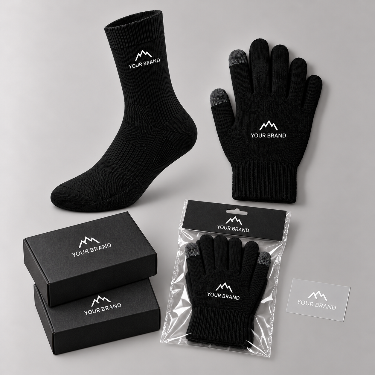 Black branded waterproof sock, touchscreen glove, sock boxes and glove hang-card packaging enclosed in a clear polybag